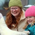 Marie and Molly Heidemann smile as molly pets Penny the turkey on Saturday at the Juneau-Douglas High School: Yadaa.at Kalé IGNITE Clubs second annual turkey shoot event. The photo shoot raised money to support the club, which hopes to build a small barn at the school. (Ben Hohenstatt / Juneau Empire)