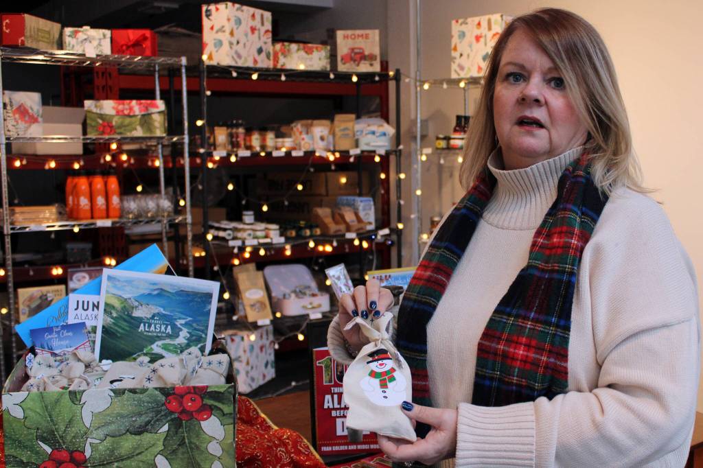 Dana Zigmund / Juneau Empire 
Midgi Moore, Juneau Food Tours CEO, shows off a Santa Bell from North Pole, Alaska, on Tuesday at the Juneau Food Tours store. The bell is one of the items included in a 12 Days of Alaskan Christmas holiday box she selling online this season. She said her online business is key to helping her hang on until next season.