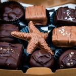 This holiday season, Angela is focused on making holiday shopping easy and rewarding by offering beautifully packaged gift boxes filled with seasonal chocolates decorated with gold leaf, local sea salts, and tied with ribbons. (Courtesy Photo / Lione Clare)