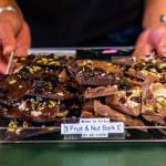 Learning how to make chocolate comes with a lot of trial and error. When Angela first bought the shop in 2017 she spent a month taking a chocolate crash course from Jackie Caywood, who used to own the shop. Angela is now passing on her chocolate-making knowledge by training her employee Gavi on how to make the delicious treats shown here. (Courtesy Photo / Lione Clare)