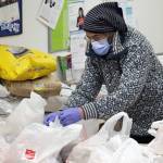 Mark Sabbatini prepares meal bags for distribution on Thursday. Bags were prepped and loaded into insulated containers before making their way to the Salvation Armys cantina, which was parked in front of the Salvation Army Family Store and Donation Center . (Ben Hohenstatt / Juneau Empire)