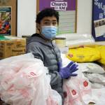 Benami Bean has plenty of bags at the ready while preparing meals for distribution on Thursday. (Ben Hohenstatt / Juneau Empire)