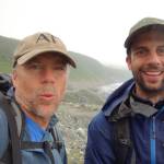 Science writer Ned Rozell, left, and UAF ecologist Ben Gaglioti pause after a slippery, seven-hour rainforest hike near La Perouse Glacier on July 3, 2021. (Courtesy Photo / Ned Rozell)
