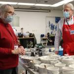 Betty Bell and Peter Metcalfe, longtime Juneau Public Market organizer, chat Friday before the market opened. (Dana Zigmund / Juneau Empire)