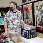 Luke Metcalfe sets up his record shop at Juneau Public Market on Friday, Nov. 26. (Dana Zigmund / Juneau Empire)