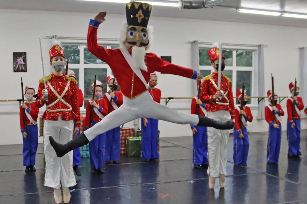 Viktor Bell rehearses his role in The Nutcracker on Saturday, Nov. 27. Lead soldiers Grace Bultez and Ainsley Mallott stand guard. (Ben Hohenstatt/Juneau Empire)