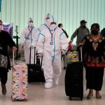 AP Photo / Jae C. Hong
Air China flight crew members in hazmat suits walk through the arrivals area Tuesday at Los Angeles International Airport. The U.S. on Wednesday reported its first case of the omicron variant.