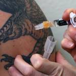 A flu shot is administered at a free vaccine clinic in Juneau on Nov. 23, 2021, and on Thursday health officials nationwide urged people to get inoculated for both COVID-19 and the flu ahead of the holiday season. (Ben Hohenstatt / Juneau Empire file)