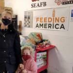 Courtesy photo/Laura Martinson 
Laura Martinson, owner of Caribou Crossings downtown and her 4-year old daughter, Olivia McDonnell, deliver food to the Southeast Alaska Food Bank.
