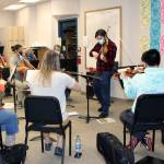 Franz Felkl, concertmaster and artistic director for the Juneau Symphony, leads a rehearsal at Juneau-Douglas High School: Yadaa.at Kalé on Dec. 7. (Dana Zigmund/Juneau Empire)