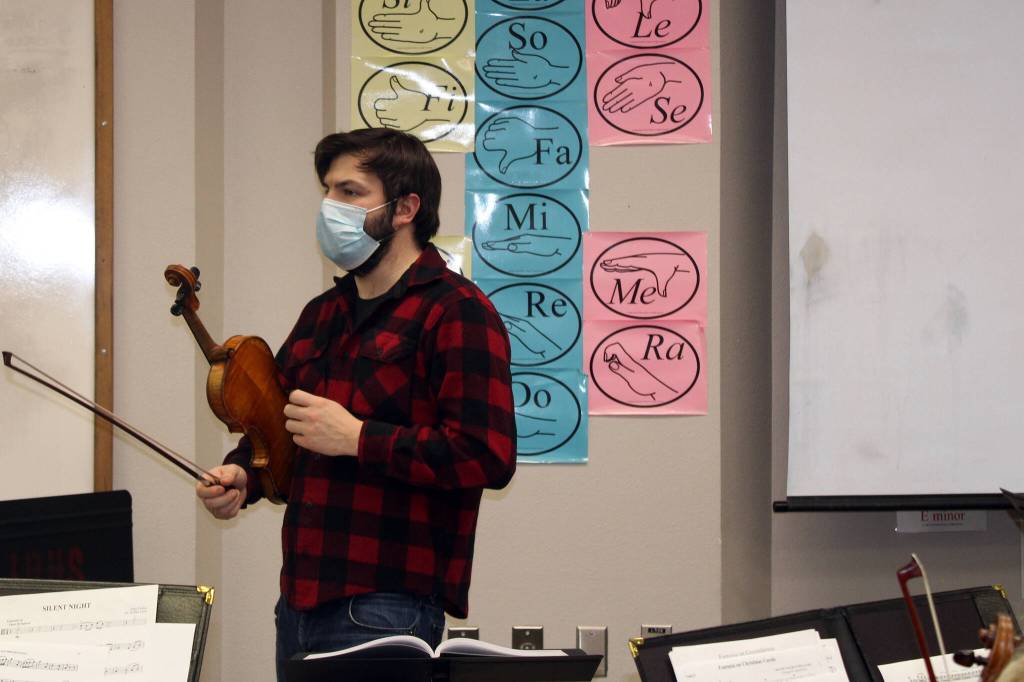 Franz Felkl, concertmaster and artistic director for the Juneau Symphony provides direction during a rehearsal at Juneau-Douglas High School: Yadaa.at Kalé on Dec. 7. (Dana Zigmund/Juneau Empire)