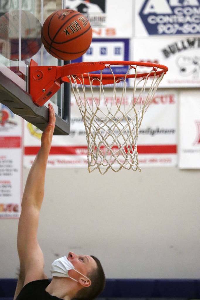 James Polasky goes up for a layup during practice at Thunder Mountain High School. (Ben Hohenstatt / Juneau Empire)