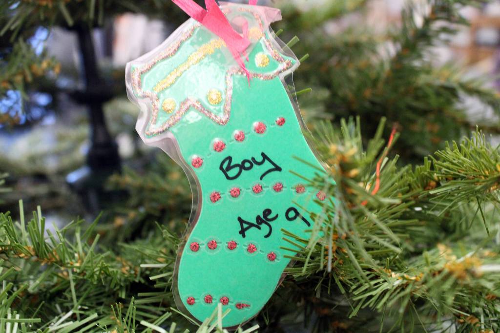 Several toy drives are underway this holiday season. A Christmas tree at the Mendenhall Mall includes ornaments that help guide shoppers who want to purchase toys for donation. (Dana Zigmund/Juneau Empire)