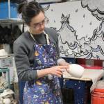 Mercedes Muñoz at work in her Lena Loop studio in Dec. 12. Her original sketch hangs in the background of her ceramics studio. (Dana Zigmund/Juneau Empire)
