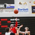 Juneau-Douglas High School: Yadaa.at Kalé varsity boys basketball players Orion Dybdahl, left and Jake Sleppy, right contest a jump ball from Coach Robert Caspersons during a practice on Dec. 14, 2021. (Michael S. Lockett / Juneau Empire)