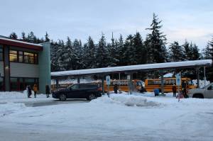 Dana Zigmund/Juneau Empire 
Buses leave Auke Bay Elementary School at the end of the school day on Dec. 16. Auke Bay is one of the school buildings that was renovated using the states school bond debt reimbursement program that allows municipalities to renovate eligible schools by reimbursing about 70% of the cost of the project if it is approved by a referendum. This type of debt funding was also used to renovate Sayéik: Gastineau Community School and Harborview elementary schools. In recent years, the state had not provided the full reimbursement amount. However, Gov. Mike Dunleavy proposed full funding for the program in the budget he unveiled Wednesday.