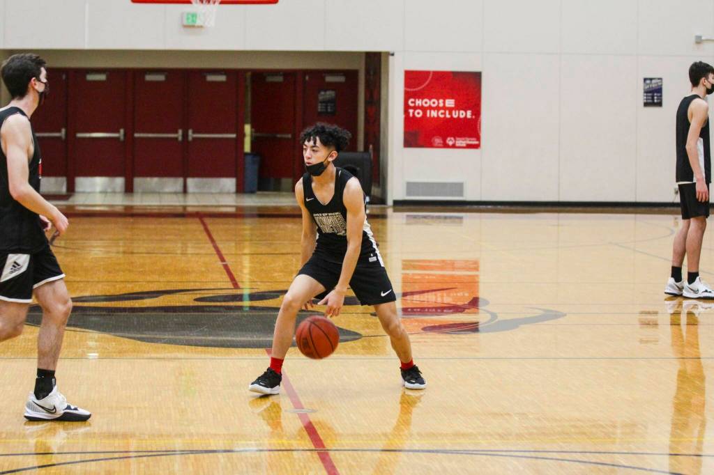 Alwen Carrillo, player for the Juneau-Douglas High School: Yadaa.at Kalé, dribbles during practice on Dec. 14, 2021. Both JDHS teams will compete in the Capital City Classic beginning on Dec. 27, 2021. (Michael S. Lockett / Juneau Empire)