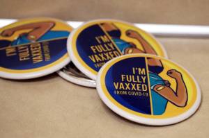 Im full vaxxed from COVID, read buttons at the Juneau Public Health Center in late November. Juneaus relatively high vaccination rate plays a role in the local response to the ongoing pandemic. At Monday nights Committee of the Whole meeting, City Assembly members agreed to move a step closer to modest relaxations to the citys COVID-19 mitigation strategies and heard from state experts who praised Juneaus performance in keeping the worst at bay so far. (Ben Hohenstatt / Juneau Empire)