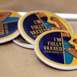 "I'm full vaxxed from COVID," read buttons at the Juneau Public Health Center in late November. Juneau's relatively high vaccination rate plays a role in the local response to the ongoing pandemic. At Monday night’s Committee of the Whole meeting, City Assembly members agreed to move a step closer to “modest relaxations” to the city’s COVID-19 mitigation strategies and heard from state experts who praised Juneau’s performance in keeping the worst at bay so far. (Ben Hohenstatt / Juneau Empire)