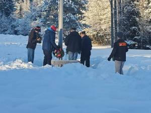 Members of the American Legion Post 25 prepare to lay wreaths Alaska Memorial Park on Dec. 18, 2021 in concert with Wreaths Across America ceremonies nationwide. The group also laid wreaths at the Shrine of St. Therese and Evergreen Cemetery that day. (Courtesy photo / American Legion Post 25)