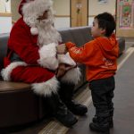 U.S. Marine Corps Gunnery Sgt. Jake Paolucci, Company Gunnery Sgt. of Delta Company, 4th Law Enforcement Battalion, Marine Forces Reserve, fist-bumps a child while dressed as Santa Claus in Kotzebue, Alaska, Dec. 11, 2021. (U.S. Marine Corps / Cpl. Brendan Mullin)