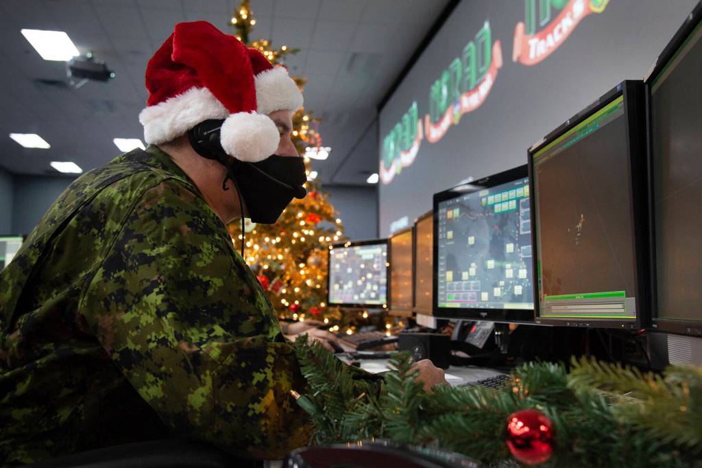 In this photo provided by the North American Aerospace Defense Command, a 22 Wing member is seen showing how they track Santa on his sleigh on Christmas evening during a media preview at the Canadian Forces Base in North Bay on Dec. 9, 2021. In a Christmas Eve tradition going on its 66th year, a wildly popular program run by the U.S. and Canadian militaries is providing real-time updates on Santas progress around the globe  and fielding calls from children who want to know St. Nicks exact whereabouts. (Sable Brown / NORAD)