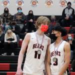 Sophomores Sean Oliver, left, and Alwen Carrillo, right, from the Juneau-Douglas High School: Yadaa.at Kalé basketball team accept all-tournament honors. (Dana Zigmund/Juneau Empire)