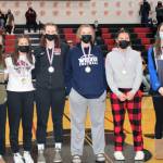 Members of the all-tournament girls team include local players, junior Kiara Kookesh, second right, and freshman Cailynn Baxter, far right, from Thunder Mountain High School. Juneau-Douglas High School: Yadaa.at Kalé players include junior Skylar Tuckwood, left, senior, Rebekah Grube, left center, and junior Ashley Laudert, who is wearing a Crimson Bears jacket. (Dana Zigmund/Juneau Empire)