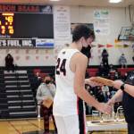 Juneau-Douglas High School: Yadaa.at Kalé junior Kai Hargrave collects his plaque from softball coach Lexie Razor after being named the boy's free-throw champ at the Princess Tours Capital City Classic on Dec. 30. (Dana Zigmund/Juneau Empire)