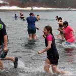 Participants rush back to shore following the 2022 Polar Dip on Saturday. (Ben Hohenstatt / Juneau Empire)