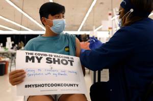 Lucas Kittikamron-Mora, 13, holds a sign in support of COVID-19 vaccinations as he receives his first Pfizer vaccination at the Cook County Public Health Department, May 13, 2021 in Des Plaines, Ill. The U.S. is expanding COVID-19 boosters as it confronts the omicron surge, with the Food and Drug Administration allowing extra Pfizer shots for children as young as 12. Boosters already are recommended for everyone 16 and older, and federal regulators on Monday, Jan. 3, 2022 decided they’re also warranted for 12- to 15-year-olds once enough time has passed since their last dose. (AP Photo / Shafkat Anowar)