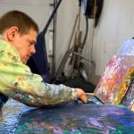 Avery Skaggs works on a painting. Skaggs work will be featured in an exhibit at the Juneau-Douglas City Museum that is opening on First Friday. (Courtesy Photo)