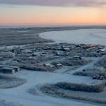 This photo provided by the U.S. Air Force/Alaska National Guard photo shows the William Miller Memorial School, larger structure top right, which is being severely eroded by the nearby Kuskokwim River in the village of Napakiak, Alaska, on Dec. 3, 2019. The school is just 64 feet (19.51 meters) from the Kuskokwim River, and it's getting closer every year. Just two years ago, the school was less than 200 feet (60.96 meters) from the river. Climate change is a contributing factor in the erosion caused by the Kuskokwim, a river that becomes an ice highway for travelers in the winter. (Airman 1st Class Emily Farnsworth, U.S. Air Force/ Alaska National Guard)