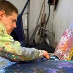Avery Skaggs works on a painting. Skaggs work is featured in a new exhibit at the Juneau-Douglas City Museum. (Courtesy Photo)
