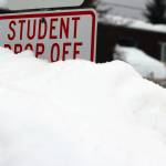 A mound of a snow obscures a student drop off sign near Sít Eetí Shaanàx-Glacier Valley School. School officials announced on Monday that classes were canceled for Tuesday due to weather. (Ben Hohenstatt / Juneau Empire)