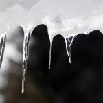 Heavy snow over the weekend was followed by rising temperatures and steady rain. This led to icy conditions and added weight to snow imperiling decks, roofs and vessels in the capital city. (Ben Hohenstatt / Juneau Empire)