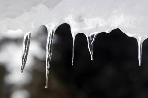 Heavy snow over the weekend was followed by rising temperatures and steady rain. This led to icy conditions and added weight to snow imperiling decks, roofs and vessels in the capital city. (Ben Hohenstatt / Juneau Empire)