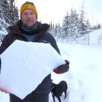 Ned Rozell holds a shard of ice crust, one-inch thick, that lurks in the middle of the Fairbanks snowpack. (Courtesy Photo / Kristen Rozell)