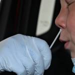 An elementary school child gets a COVID-19 test at the Hegevig Regional Fire Training Center on Aug. 27. Testing is still available at the site. In addition, the federal government is mailing at-home tests to people who request them. (Dana Zigmund/Juneau Empire)