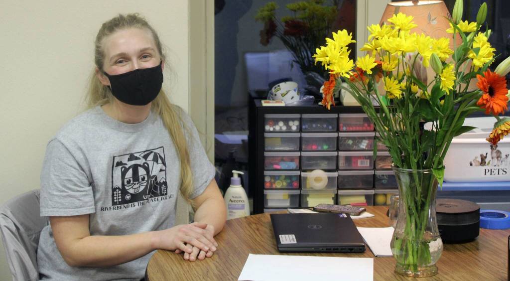 Teacher Amanda Swanson sits at her temporary desk in the education wing of the Chapel by the Lake church near Auke Bay on Jan. 21. Swanson was welcoming first grade students from Riverbend Elementary School to their temporary classroom at an open house event ahead of the first day of school at the site. (Dana Zigmund/Juneau Empire)