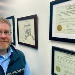 Attorney Scott Kendall stands next to the State of Alaska certificate for the election reforms he helped author in a successful ballot initiative in Anchorage, Alaska, on Jan. 21, 2022. Alaska elections will be held for the first time this year under a voter-backed system that scraps party primaries and sends the top four vote-getters regardless of party to the general election, where ranked choice voting will be used to determine a winner. No other state conducts its elections with that same combination. (AP Photo / Mark Thiessen)