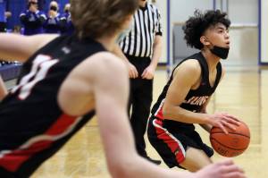 Alwen Carrillo coils up to launch a shot in a 63-50 win at Thunder Mountain High School on Friday night. Carillo led the Crimson Bears in scoring 21 points and made some slick passes to set his teammates up for easy buckets. (Ben Hohenstatt / Juneau Empire)