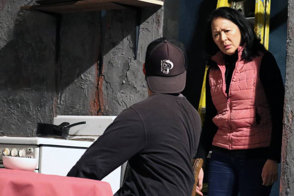 Tasanee (Leslie Ishii) casts a stern glance at Max (Mike Rao) after a bout of bickering between Max and his brother.