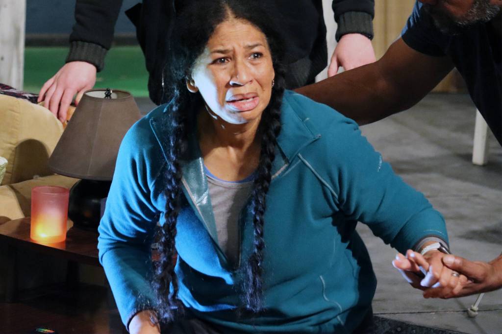 A flashlights beam casts extra light on the frightened face of Della (Vivian Melde) during rehearsal for The Brothers Paranormal. (Ben Hohenstatt / Juneau Empire)