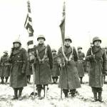 The Color Guard of the 442nd RCT stands at attention while citations are read following the fierce fighting in the Vosges area of France on November 12, 1944. (Courtesy photo / United States Army Signal Corps)