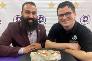 Dan Newman, left, the founder of Alaska Premier Auctions and Appraisers, and Nick Cline, a business partner, pose Friday, Feb. 18, 2022, in Anchorage, Alaska, with the "Americus Australis," thought to be one the largest gem-quality opals in existence. The gem will be offered at auction Sunday, Feb. 20, 2022, with an opening bid set at $125,000 (AP Photo / Mark Thiessen)