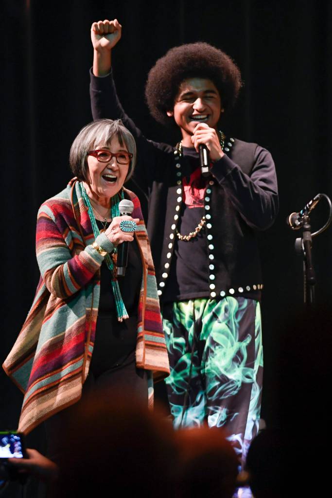 Rosita Worl, president of the Sealaska Heritage Institute, celebrates the performance of hip-hop duo of Arias A.J. Hoyle, right, and Chris Talley as an opening act before Khu.eex performance at Centennial Hall on Monday, Jan. 28, 2019. (Michael Penn / Juneau Empire File)