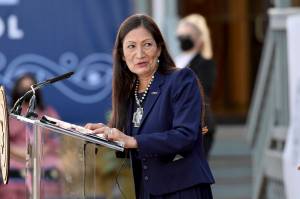 Interior Secretary Deb Haaland speaks at the Cherokee Immersion School Friday, Dec. 3, 2021, in Tahlequah, Okla. Federal officials have come up with a list of potential replacement names for hundreds of geographic features in three dozen states that include the word "squaw." Haaland in November formally declared the term derogatory and initiated a process to remove the term from use by the federal government and to replace other existing derogatory place names. The list was announced Tuesday, Feb. 22, 2022. (AP Photo/Michael Woods,File)
