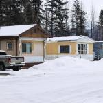 Juneau police officers hunkered down next to the berm visible between homes, said an eyewitness, before an officer fired his weapon three times and striking two trailers, mistakenly believing a man having a mental health crisis had a gun on Tuesday, Feb. 22, 2022. (Michael S. Lockett / Juneau Empire)