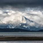 This photo shows the view from Eagle Beach looking across to Mount Golub emerging through the cloud, with Lincoln Island in the foreground. (Courtesy Photo / Kenneth Gill, gillfoto)
